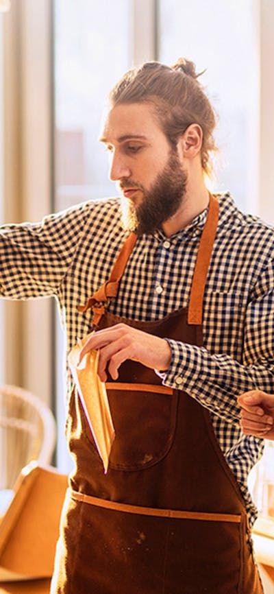 Man wearing checkered shirt serving lady wearing denim jacket