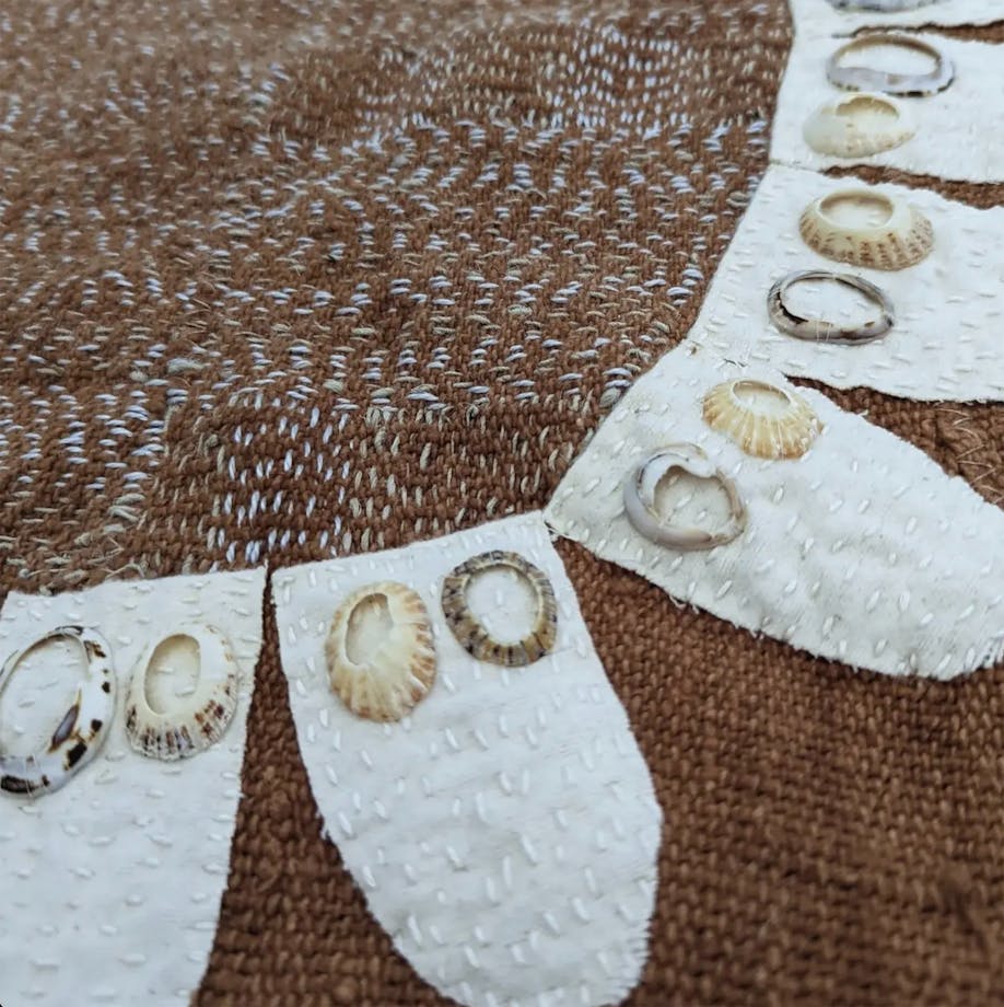 brown textile with white fabric petals and shells