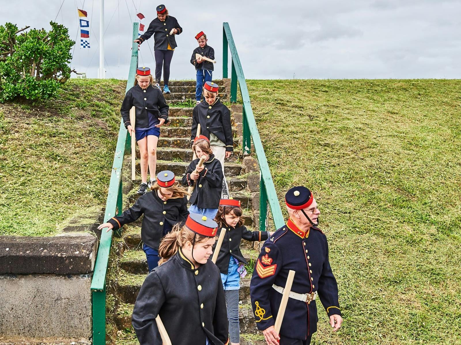 a group of people in uniform stepping down stairs