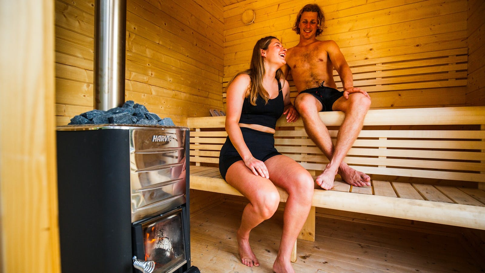 A couple enjoying a wood fired sauna at maydena bike park