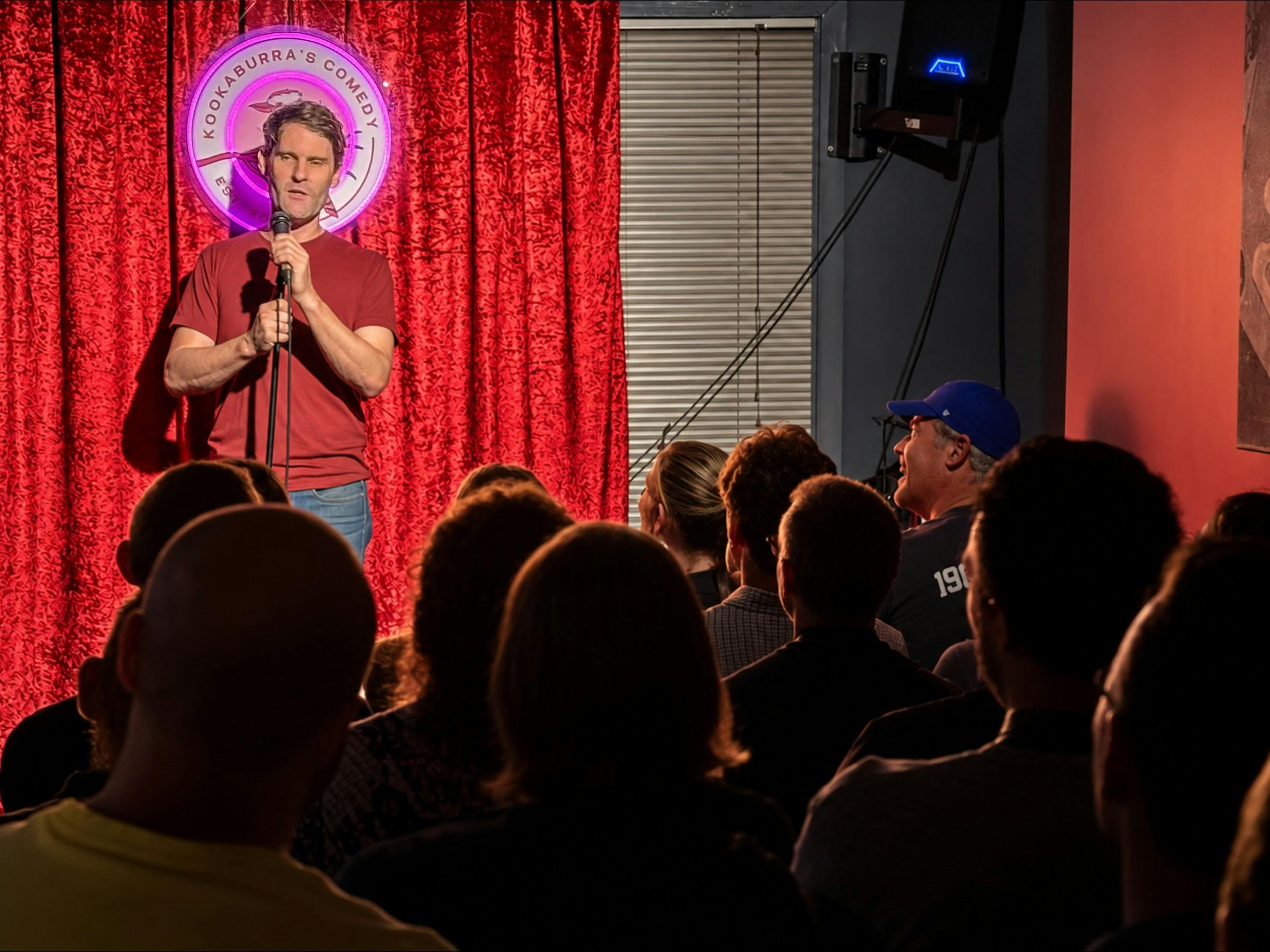 Smiling and laughing audience at a stand-up comedy show in Sydney