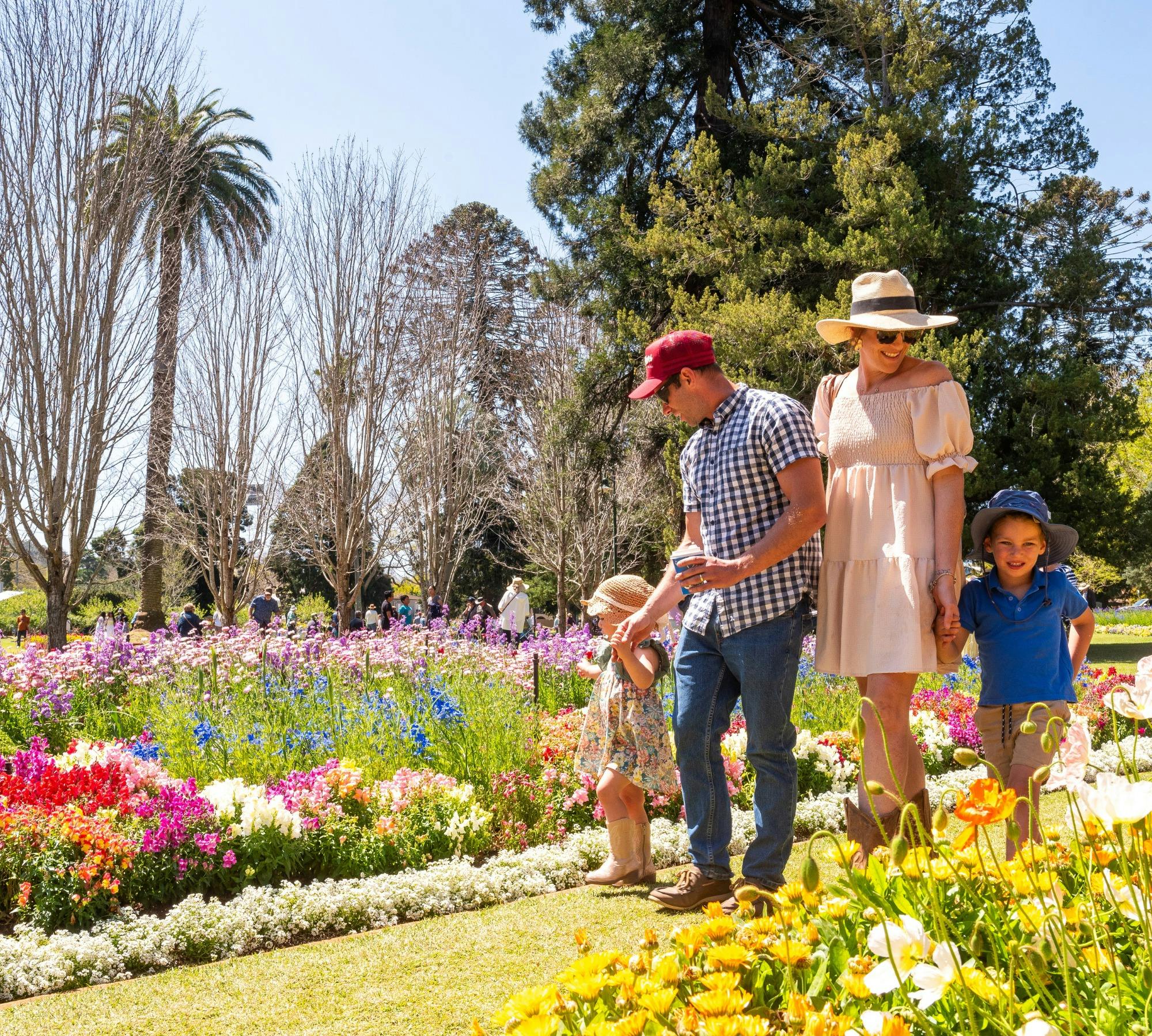 Family enjoying floral display at Queens Park Botanic Gardens