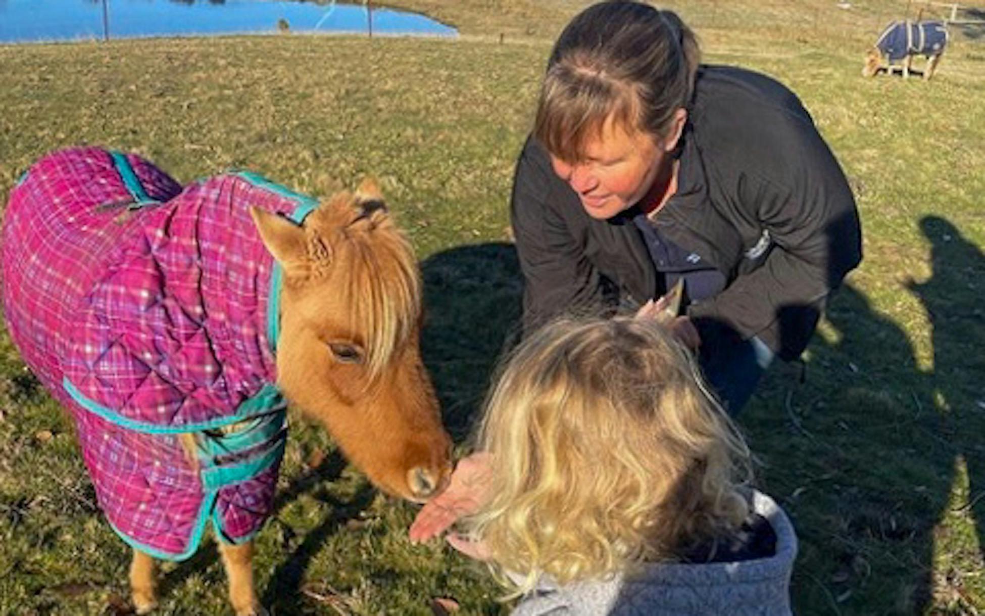 Lady and child with miniature Horse