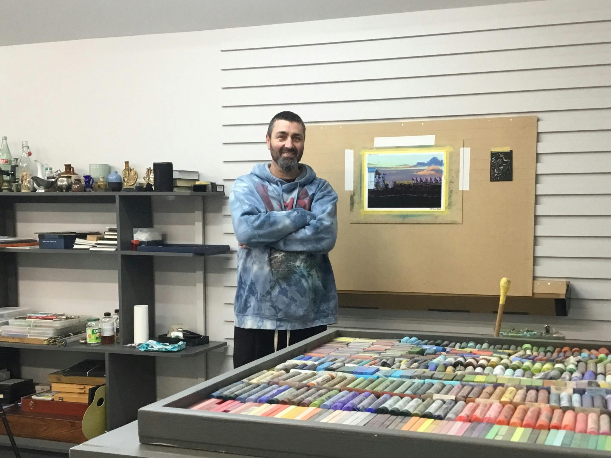 Ricky in front of is new work space.