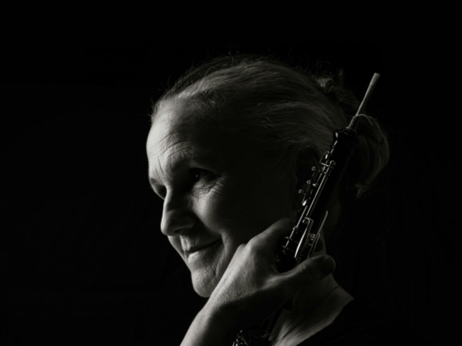 Black-and-white portrait of an oboe player in profile, looking toward the light Black-and-white portrait of an oboe player in profile, looking toward the light