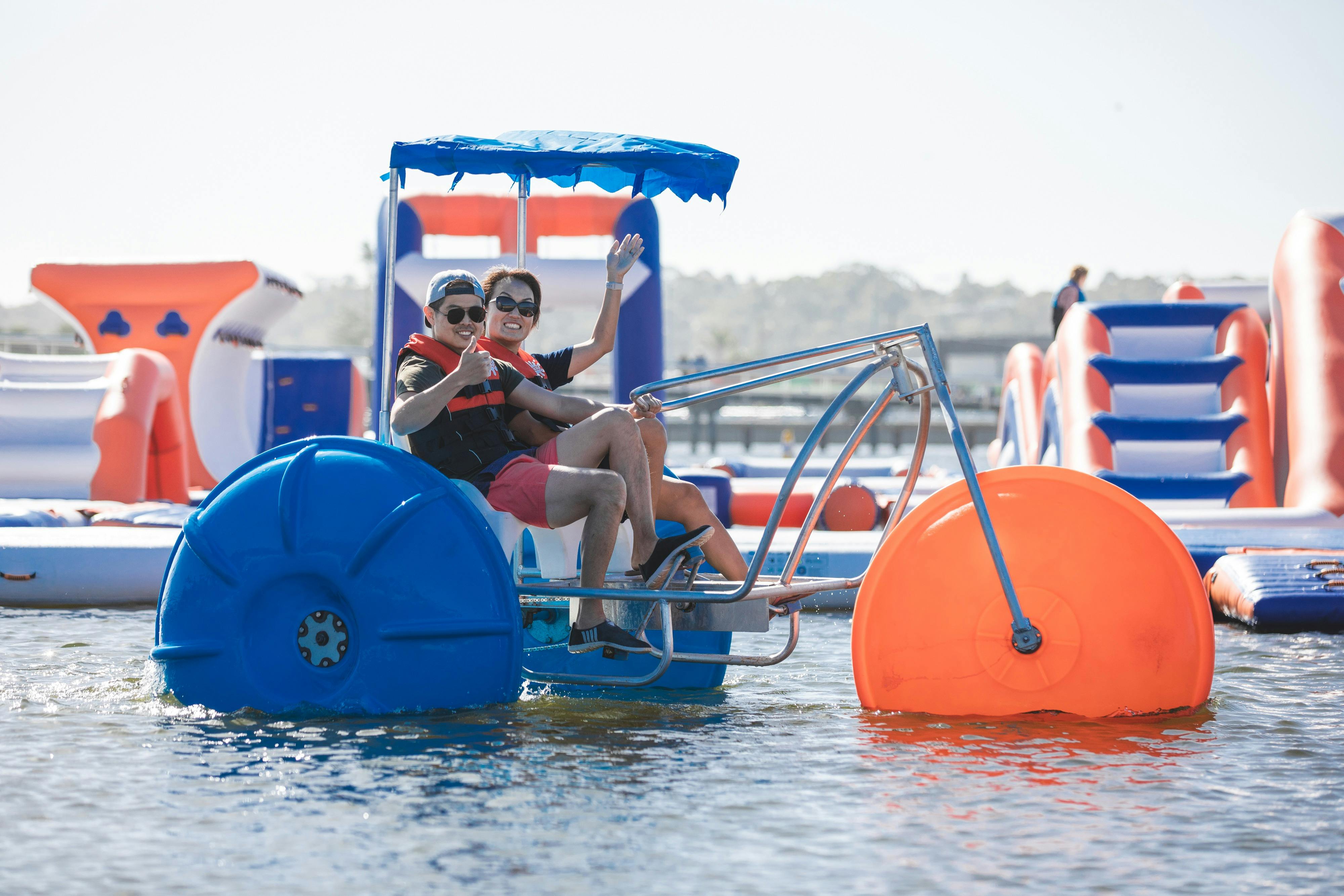 Two people on Giant paddle bikes
