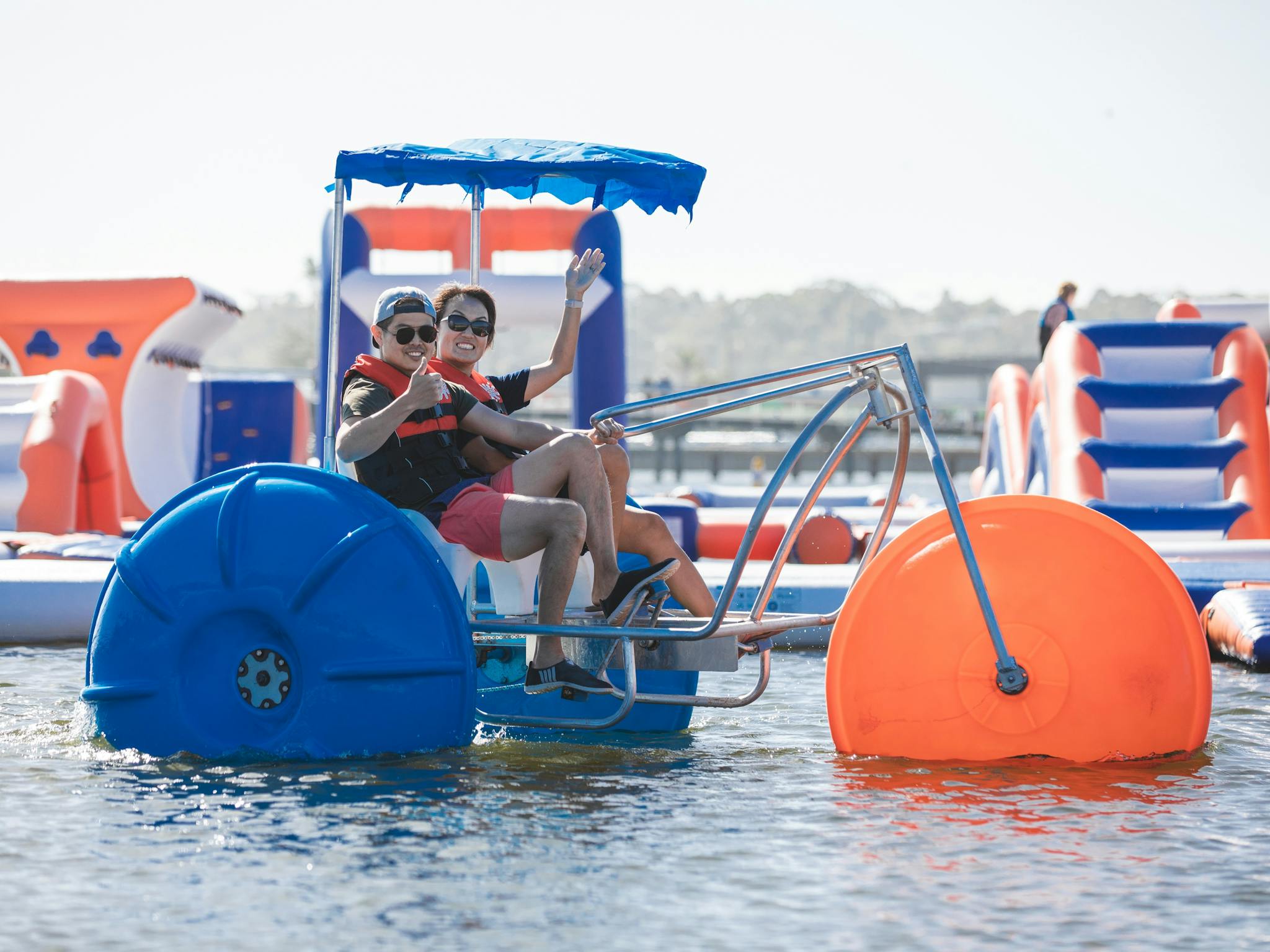 Two people on Giant paddle bikes