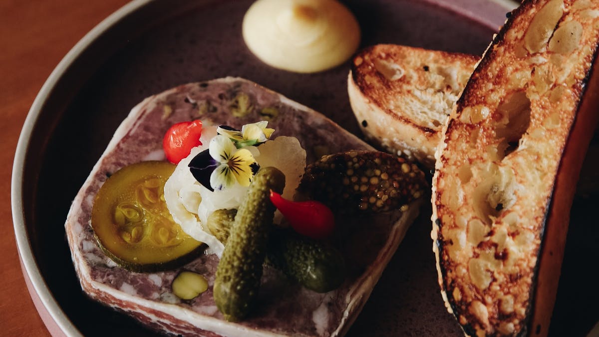 Our 'Signature House Terrine' with apple butter, truffle seeded mustard & zucchini pickles.