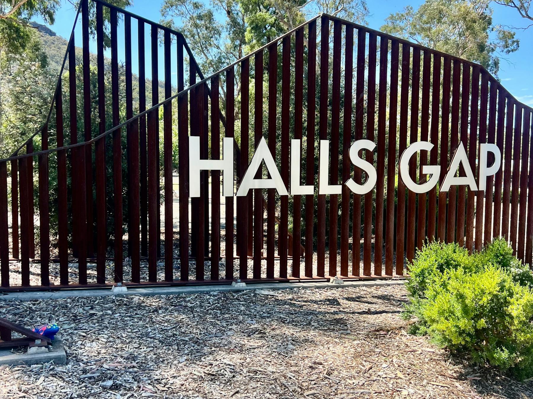 Large sign with the words Halls Gap on a fence
