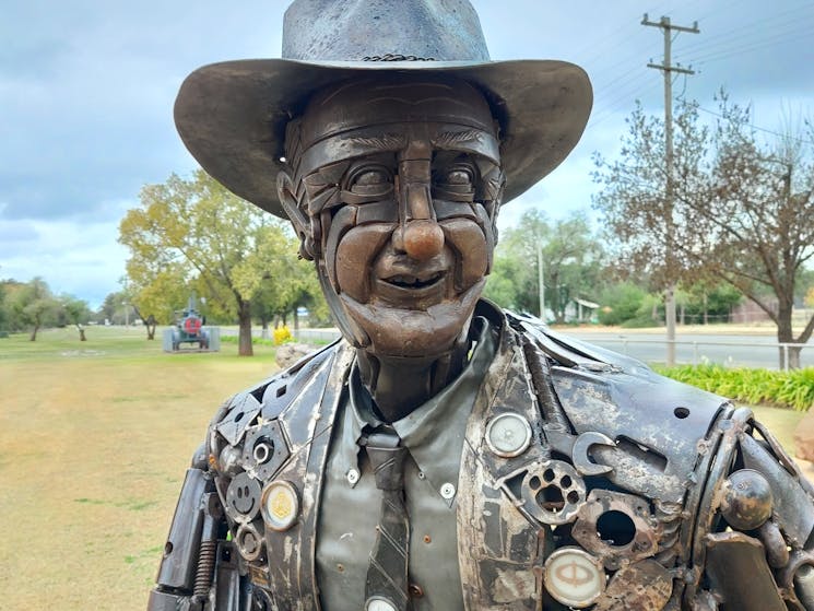 A close up of the face of the Tim Fischer metal sculpture at Boree Creek