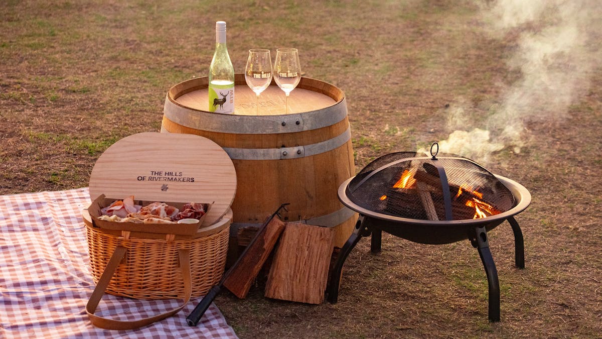 Wood-fired firepit, with a picnic basket and basket, wine and charcuterie board
