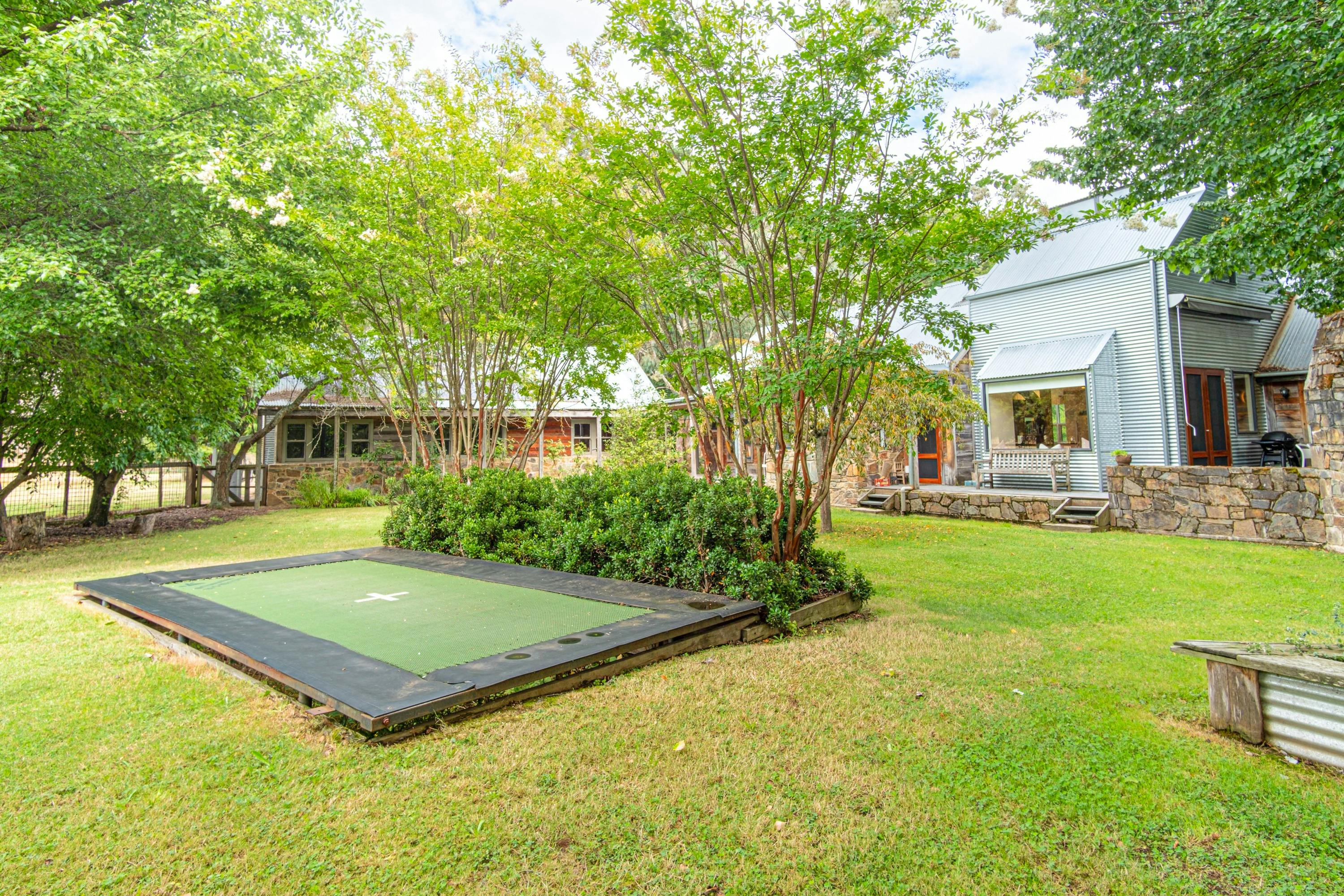 Back garden outdoor fireplace, alfresco area, trampoline and mountain views