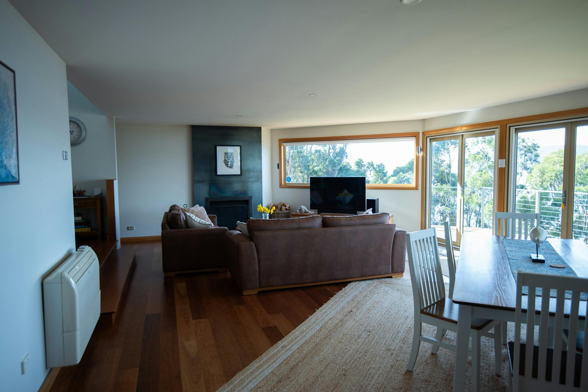 Leather couch, tv, fireplace, dinning room table and chairs