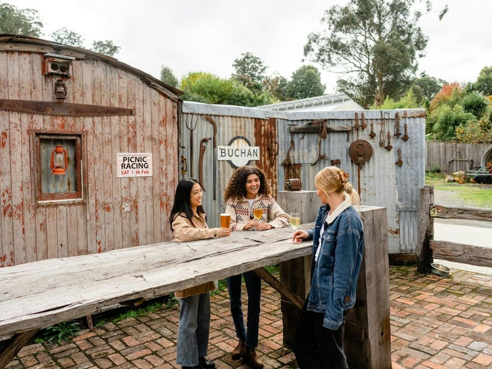 Three women around a table talking