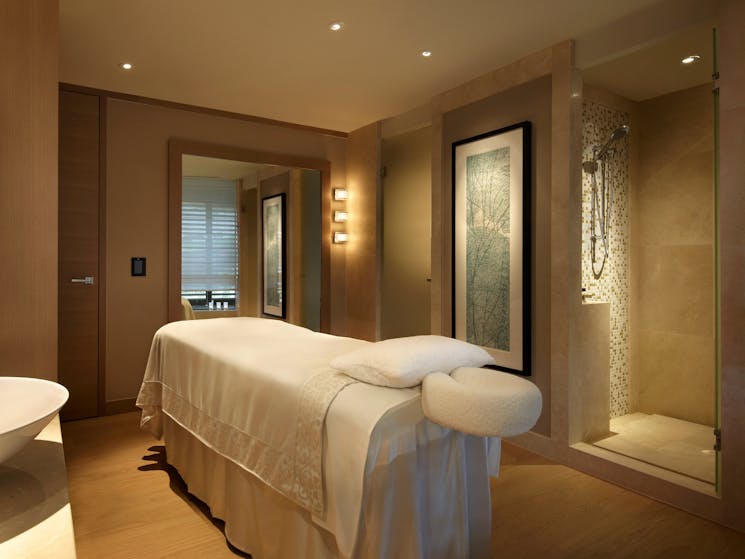 Treatment room featuring massage bed and marble shower in The Spa at Park Hyatt Sydney