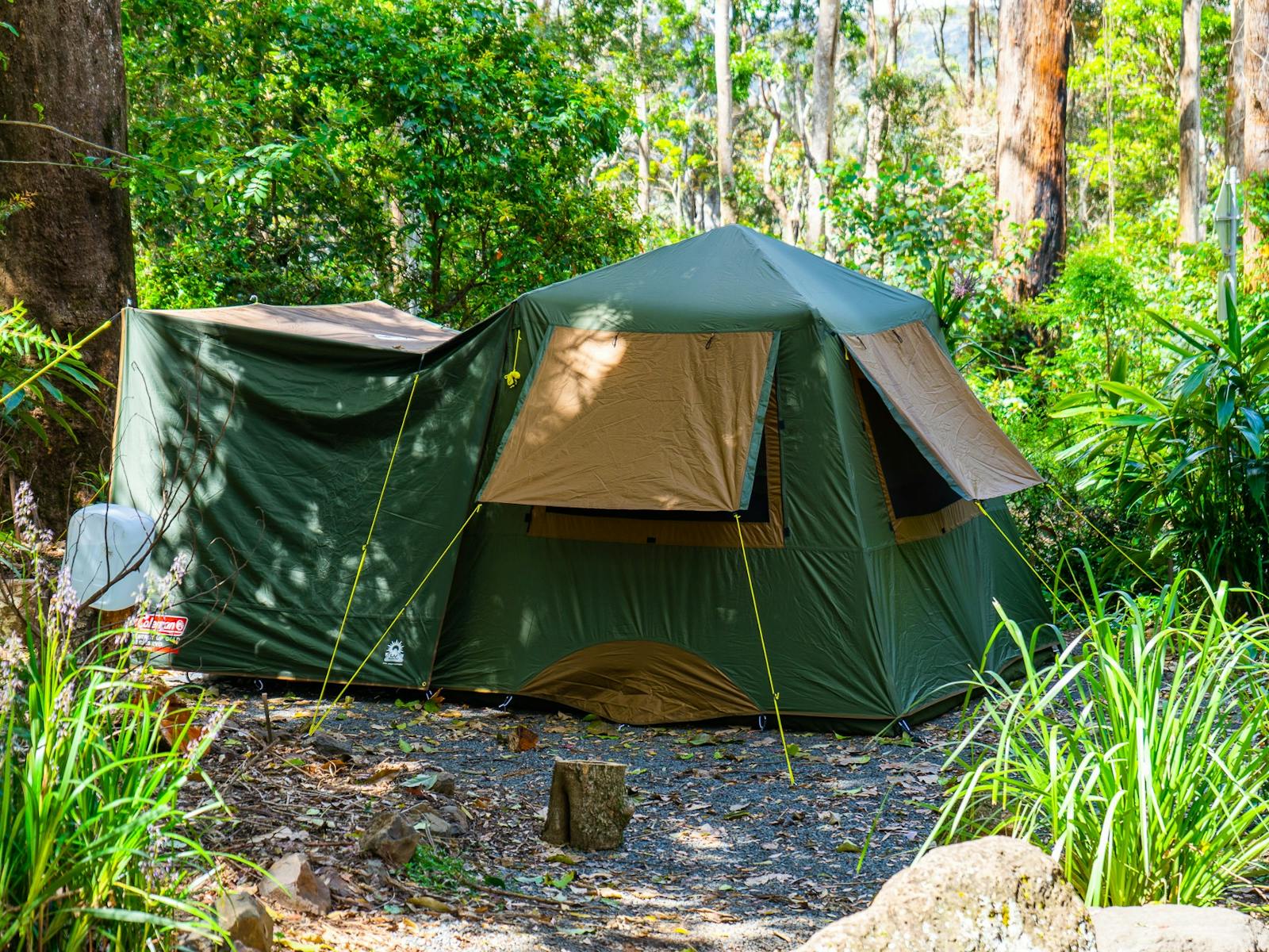 Image shows a large tent set up on a campsite Image shows a large tent set up on a campsite