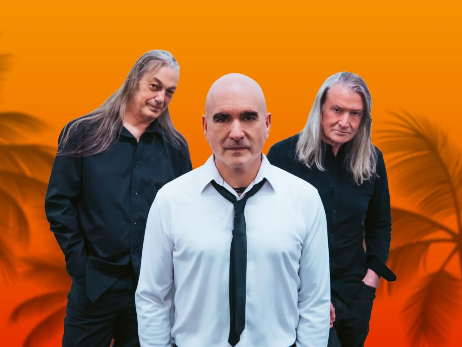 3 men 2 in background with long grey hair man in front with white shirt and black loose tie