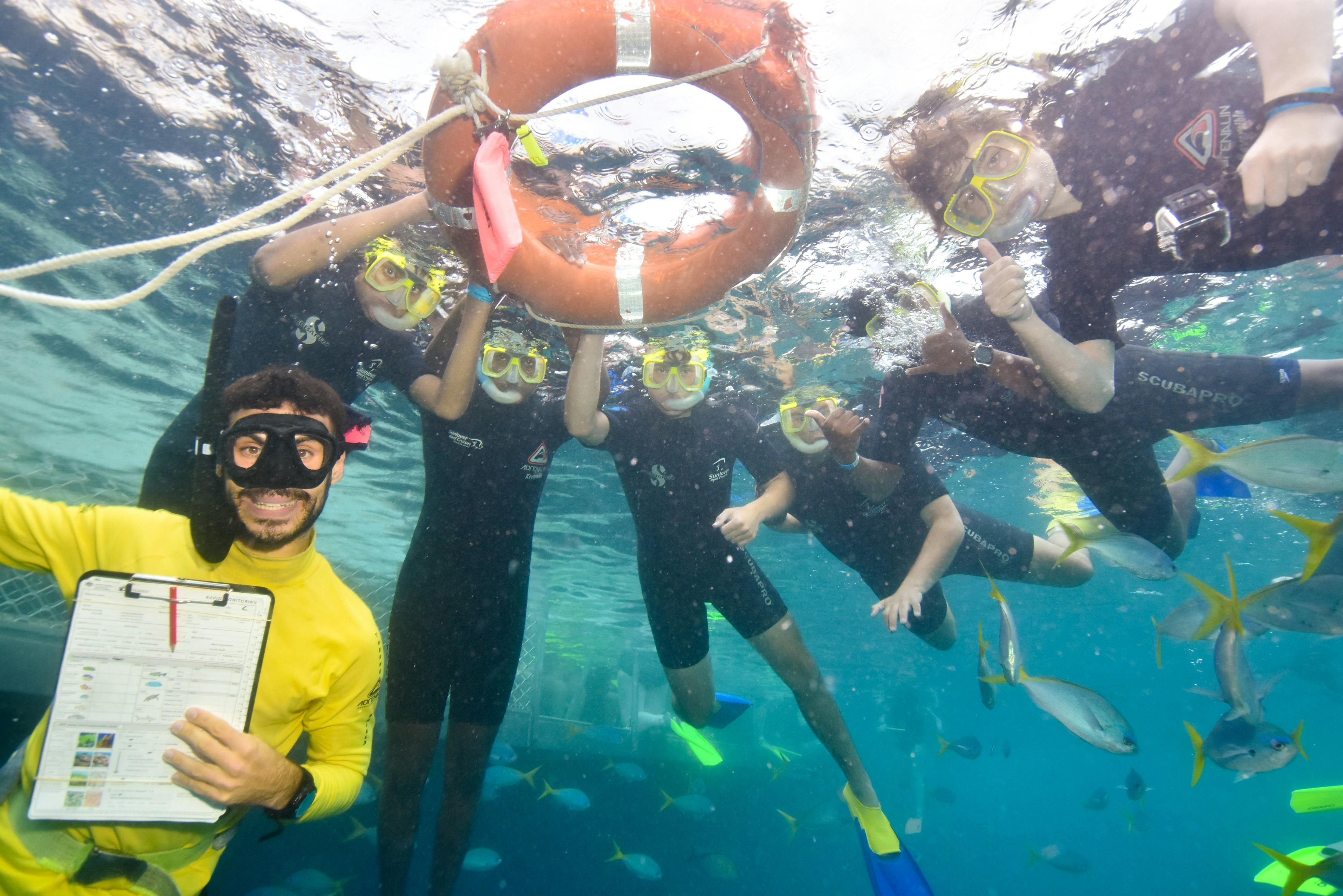 Marine Biologist instructor with students in open water.