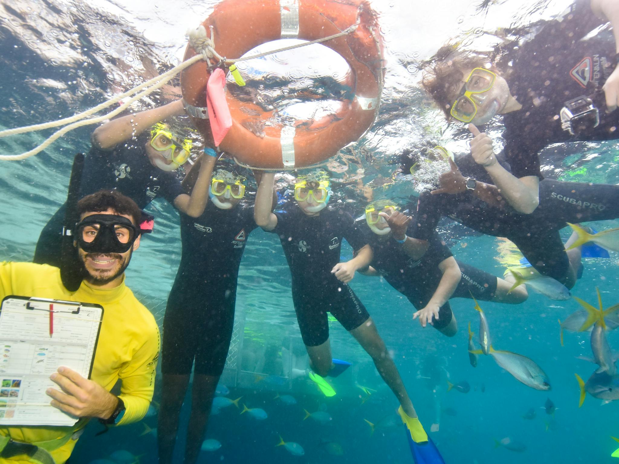 Marine Biologist instructor with students in open water. Marine Biologist instructor with students in open water.
