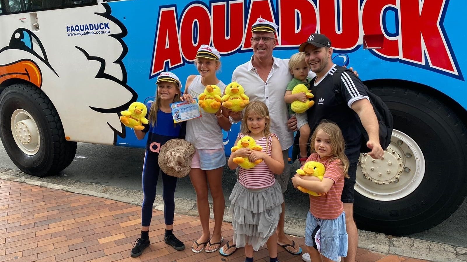 family in front of the aquaduck