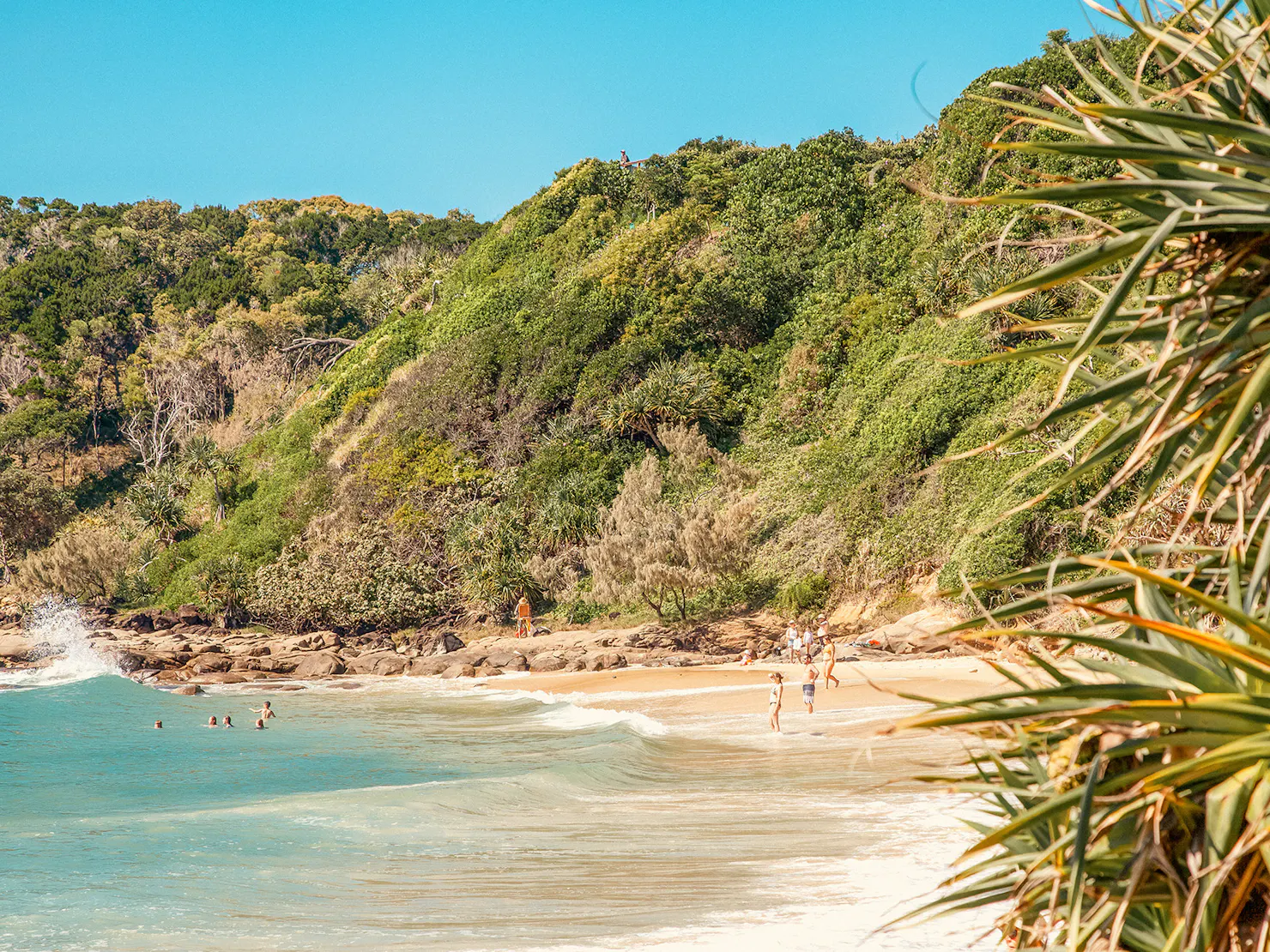 Swimmers enjoy the clear waters of First Bay, Coolum Beach, Sunshine Coast.