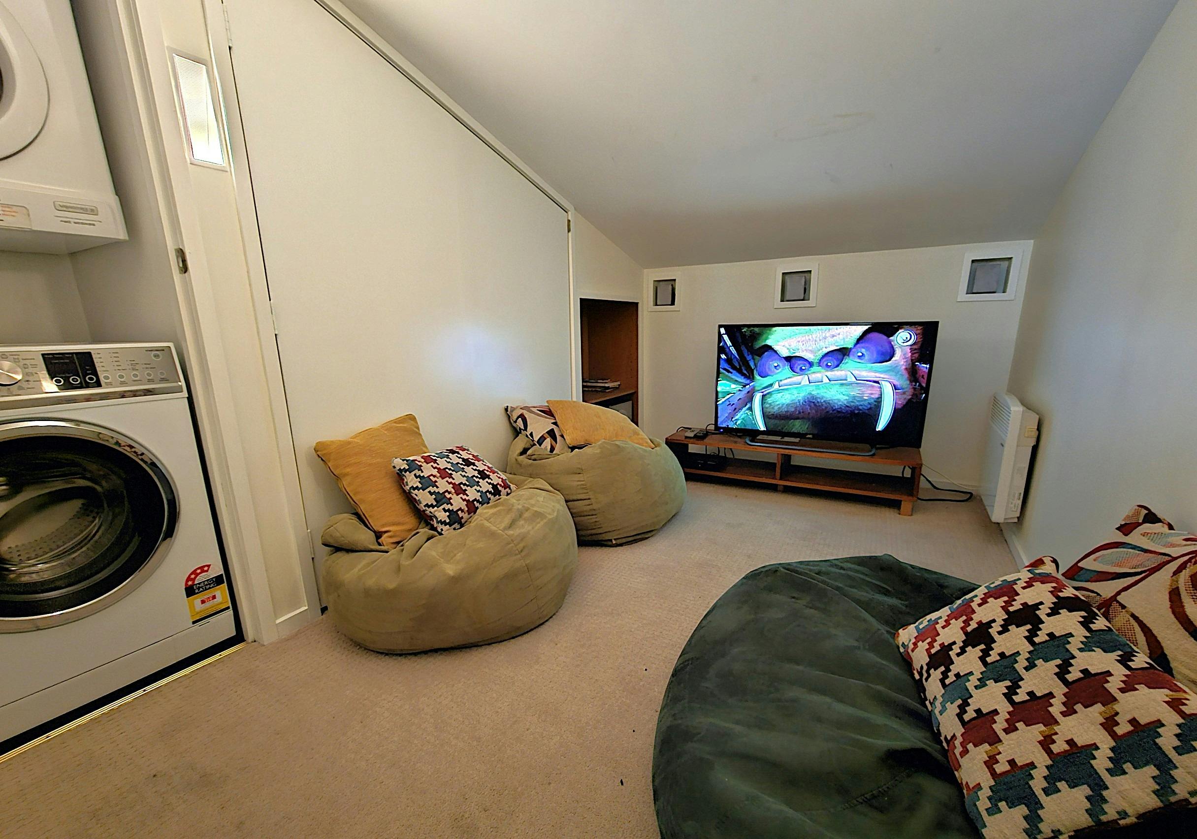 Room with bean bags and a television