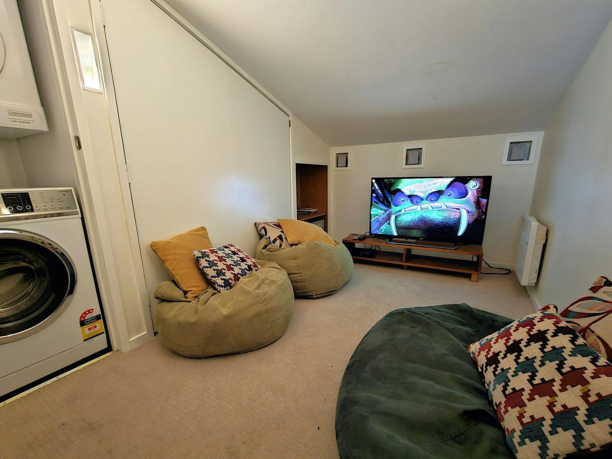 Room with bean bags and a television