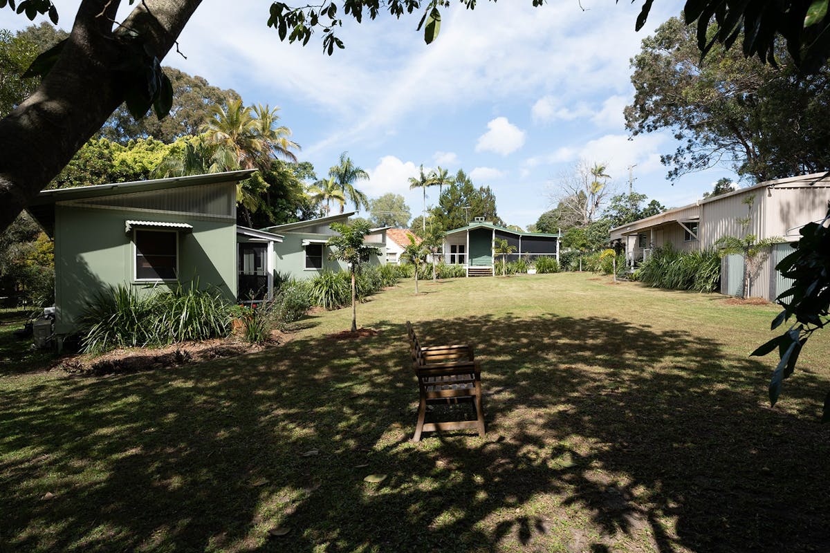 Shady grounds with plenty of grass with the Gindabara buildings in the distance.