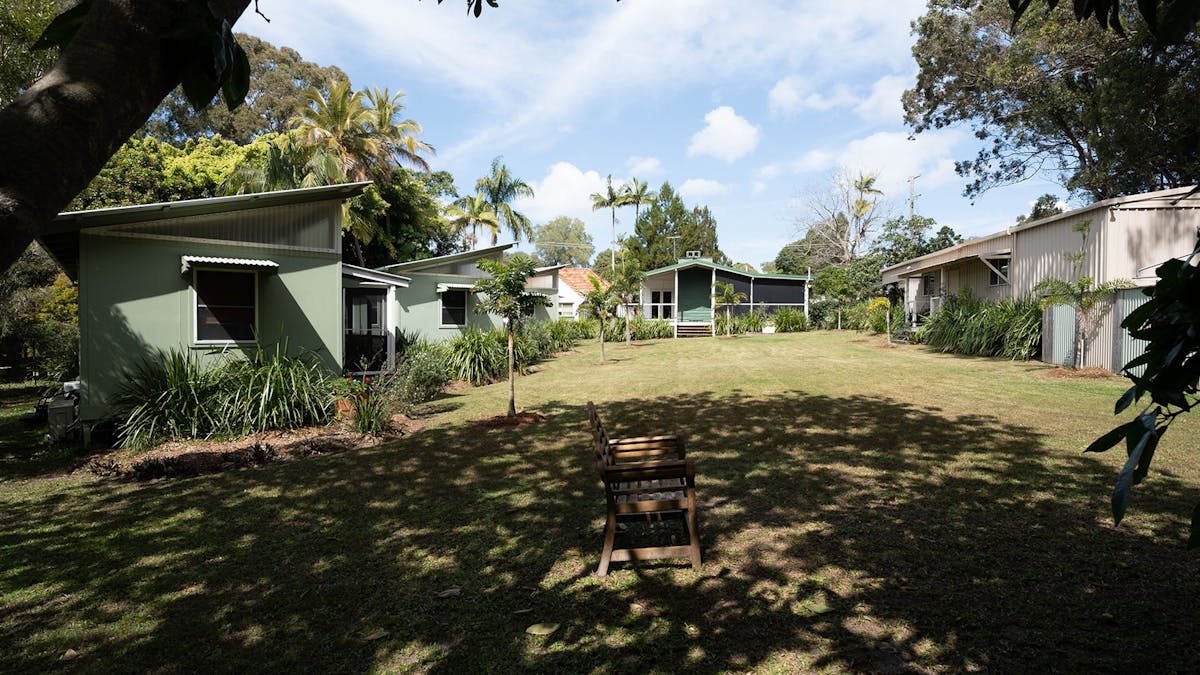 Shady grounds with plenty of grass with the Gindabara buildings in the distance.