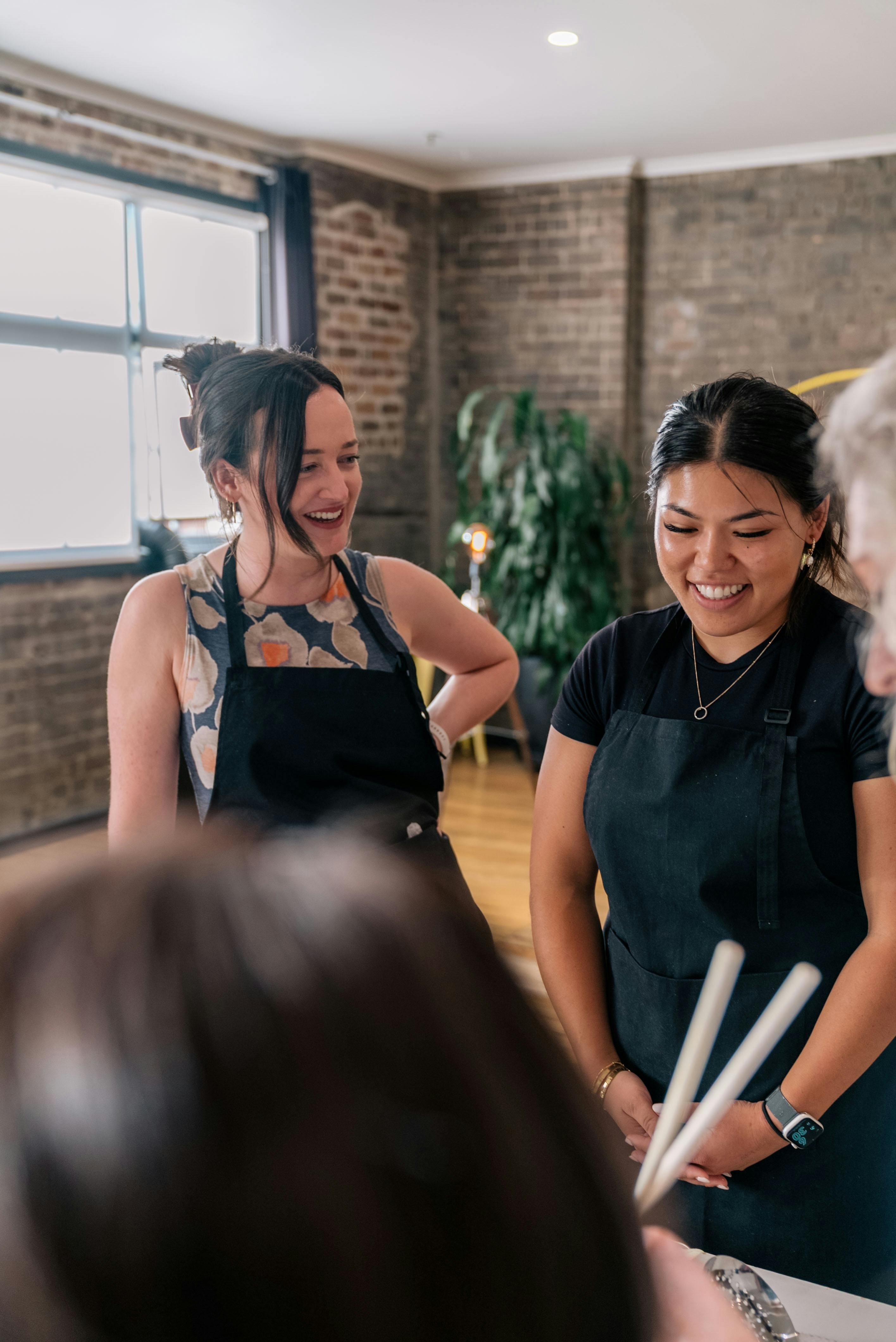 Two women making jokes and talking during the class