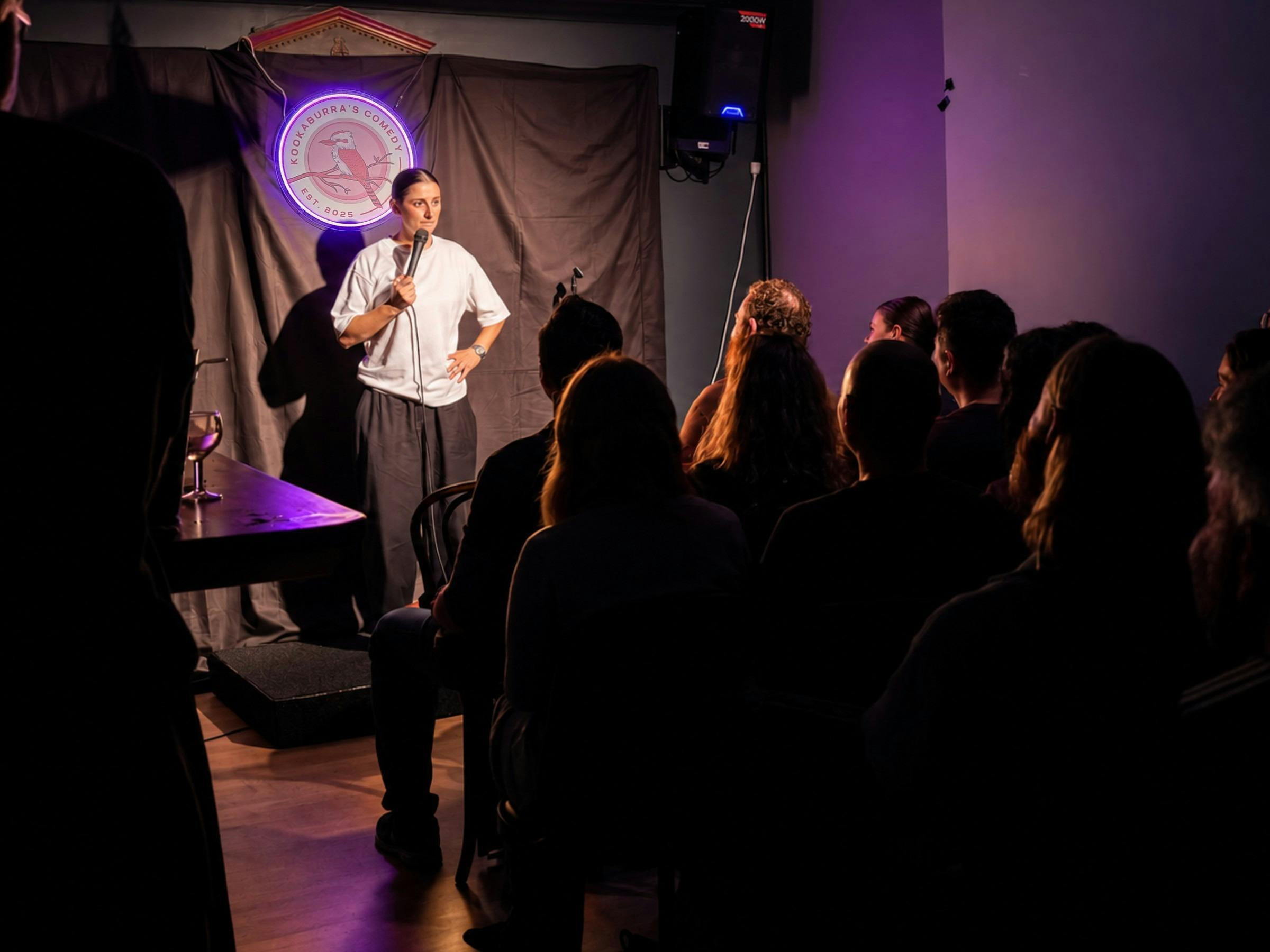 People laughing together at a live comedy night in a Glebe bar