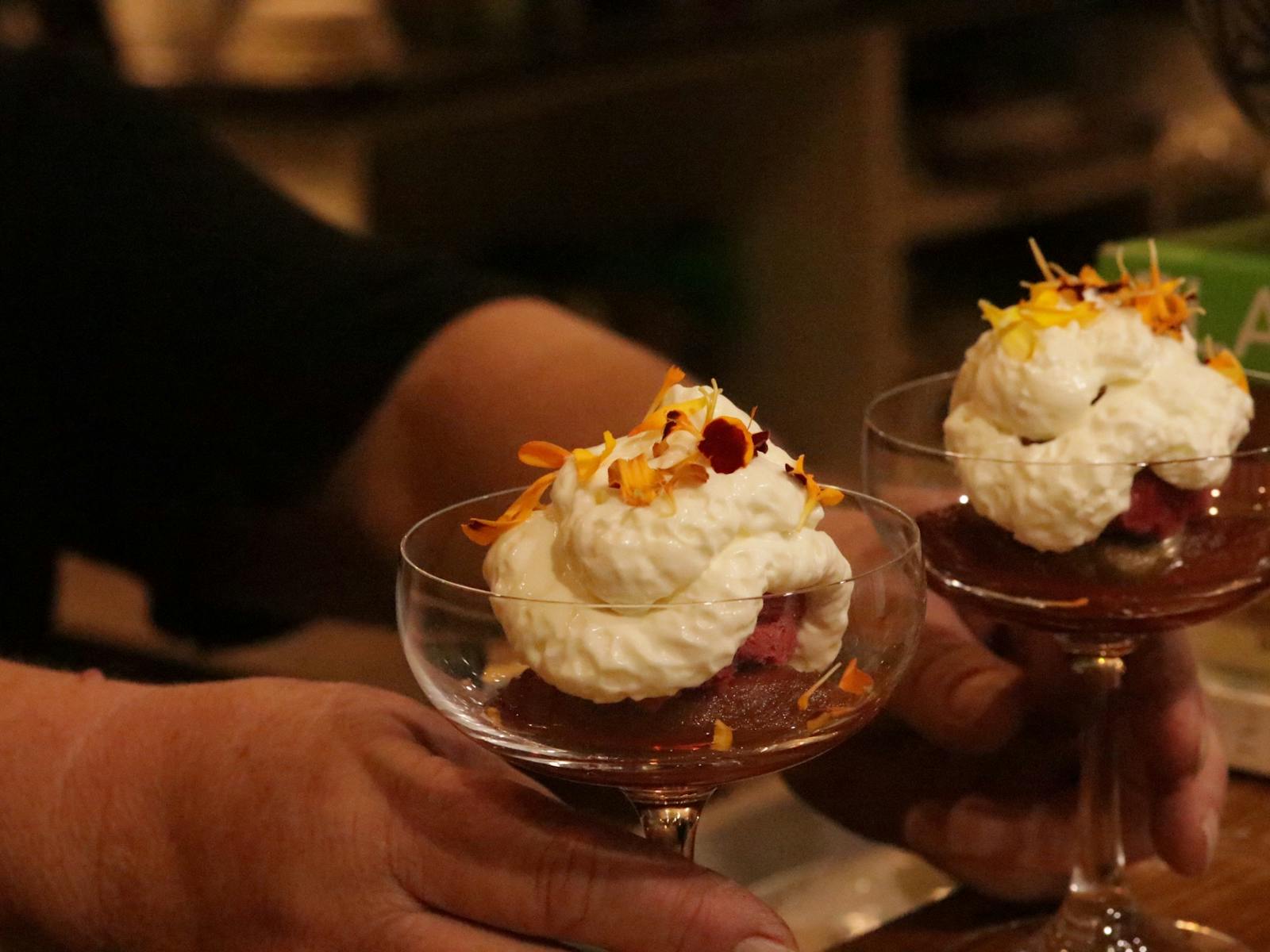 Poached Quince with Raspberry Sorbet and Yoghurt mousse in a couple glass with orange flowers