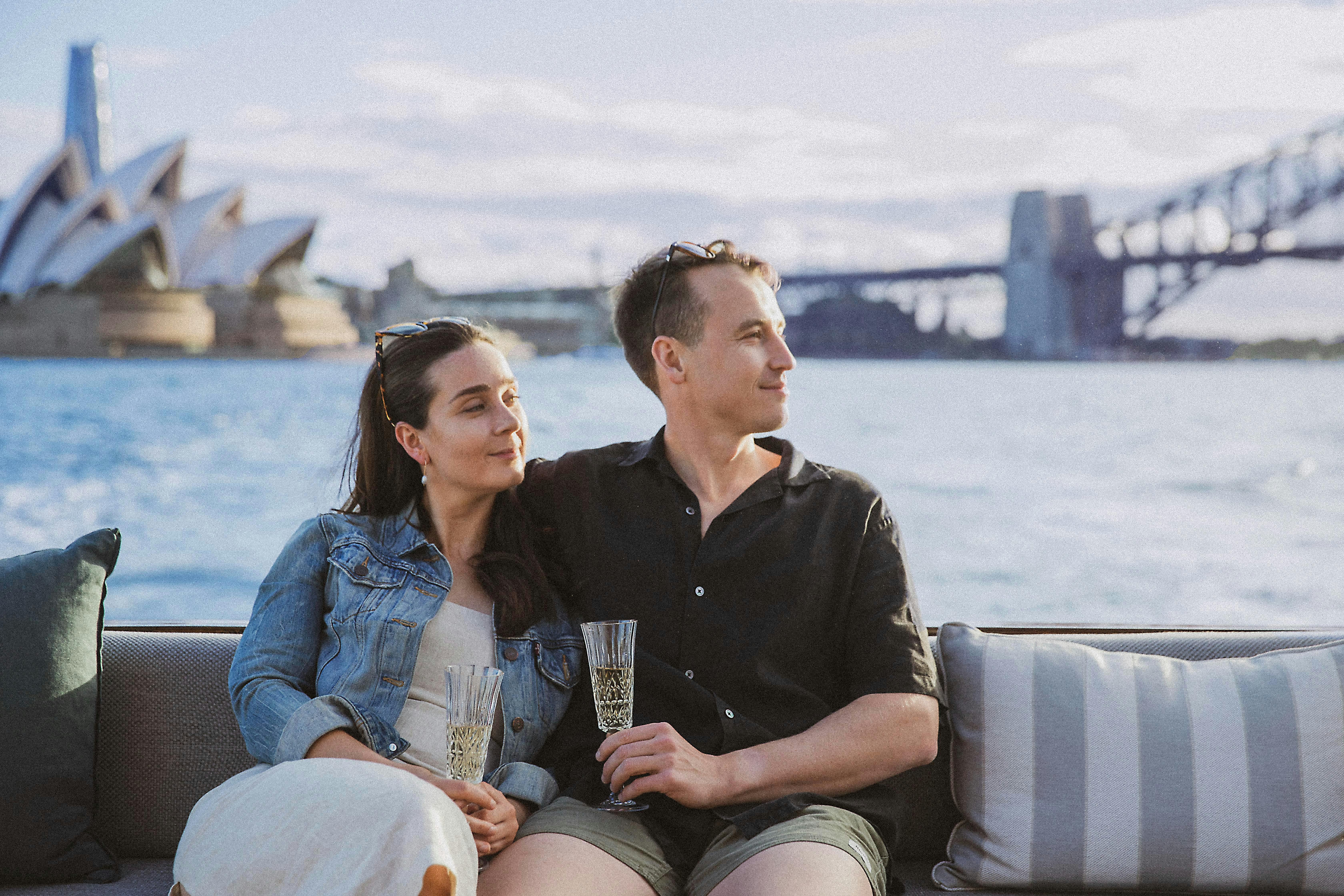 couple on back of boat with champagne