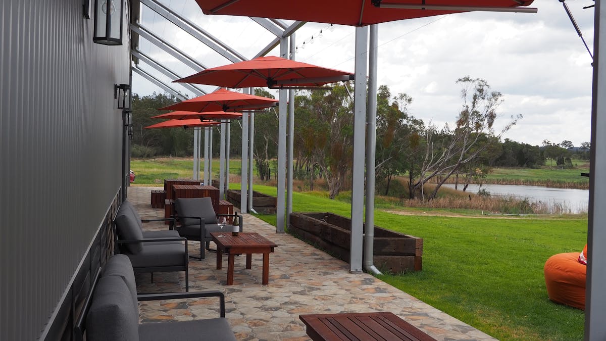 Outdoor seating looking over beautiful lawn space and estate vineyards