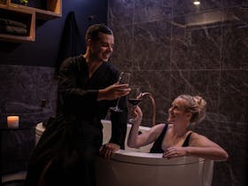 Enjoying a glass of Coonawarra Wine while relaxing in the spa with your partner.