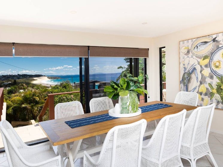 Dining room with modern coastal setting and ocean views