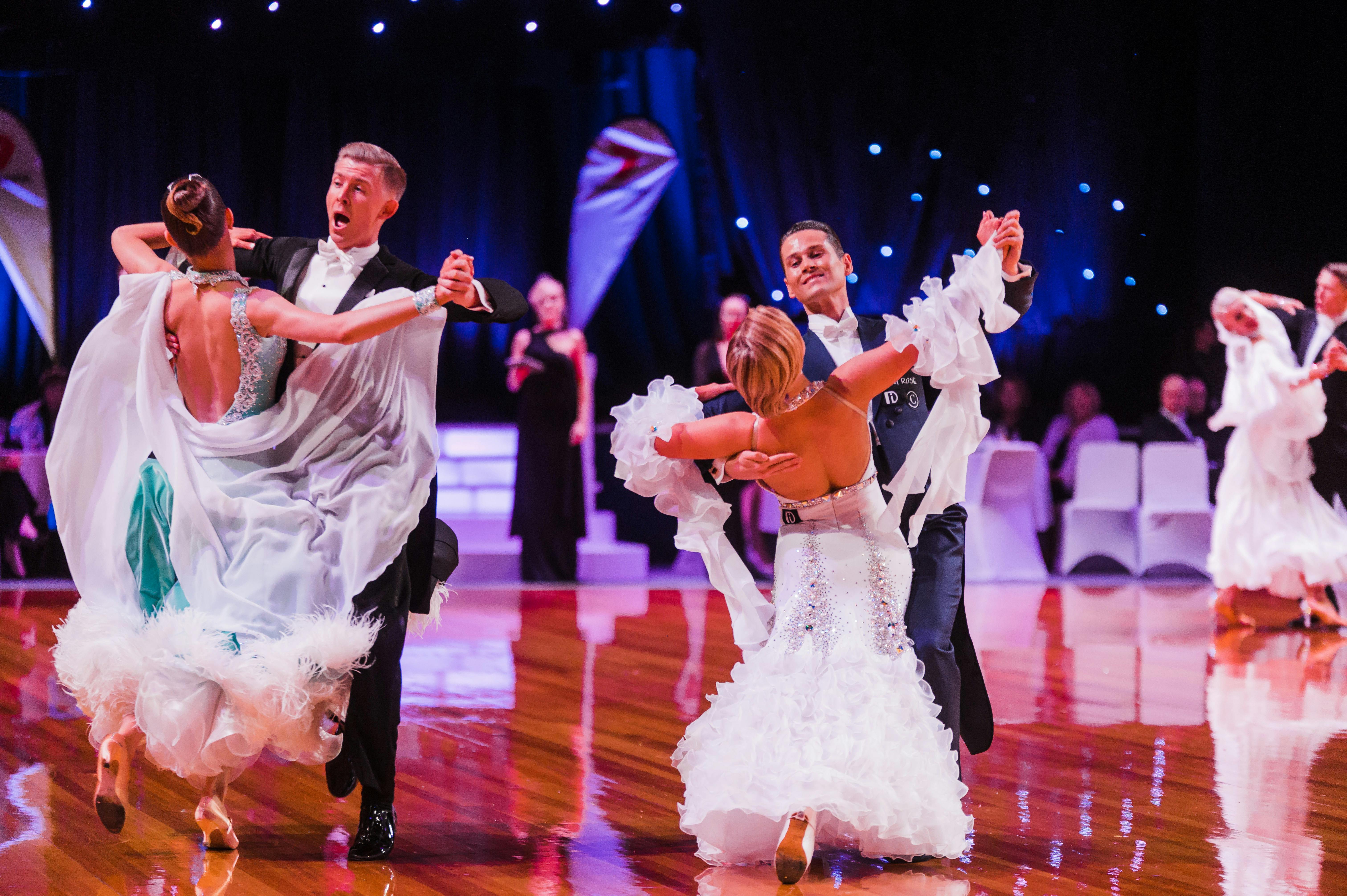 2 couples dancing ballroom with audience watching