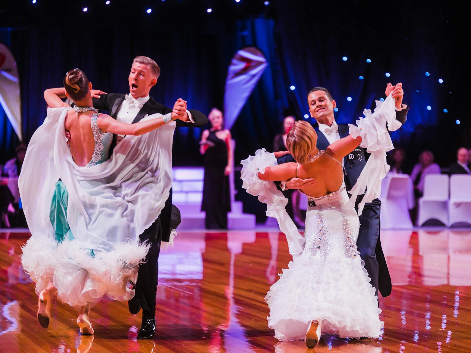 2 couples dancing ballroom with audience watching