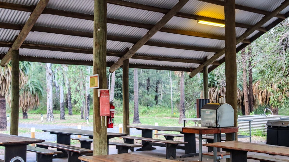 Large outdoor camp kitchen with pizza oven.