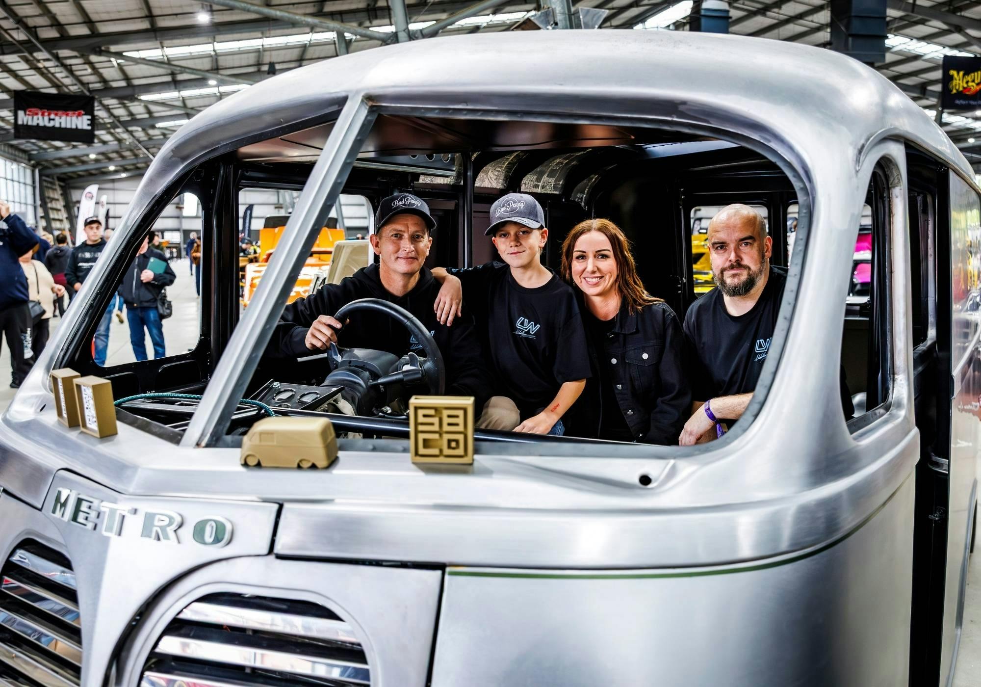 Four entrants sitting inside the unfinished cab of a custom-built vehicle at MotorEx.