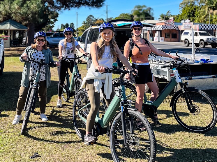 Group of ladies on bikes leaving Mooball on the husk distillery and rail trail e bike tour