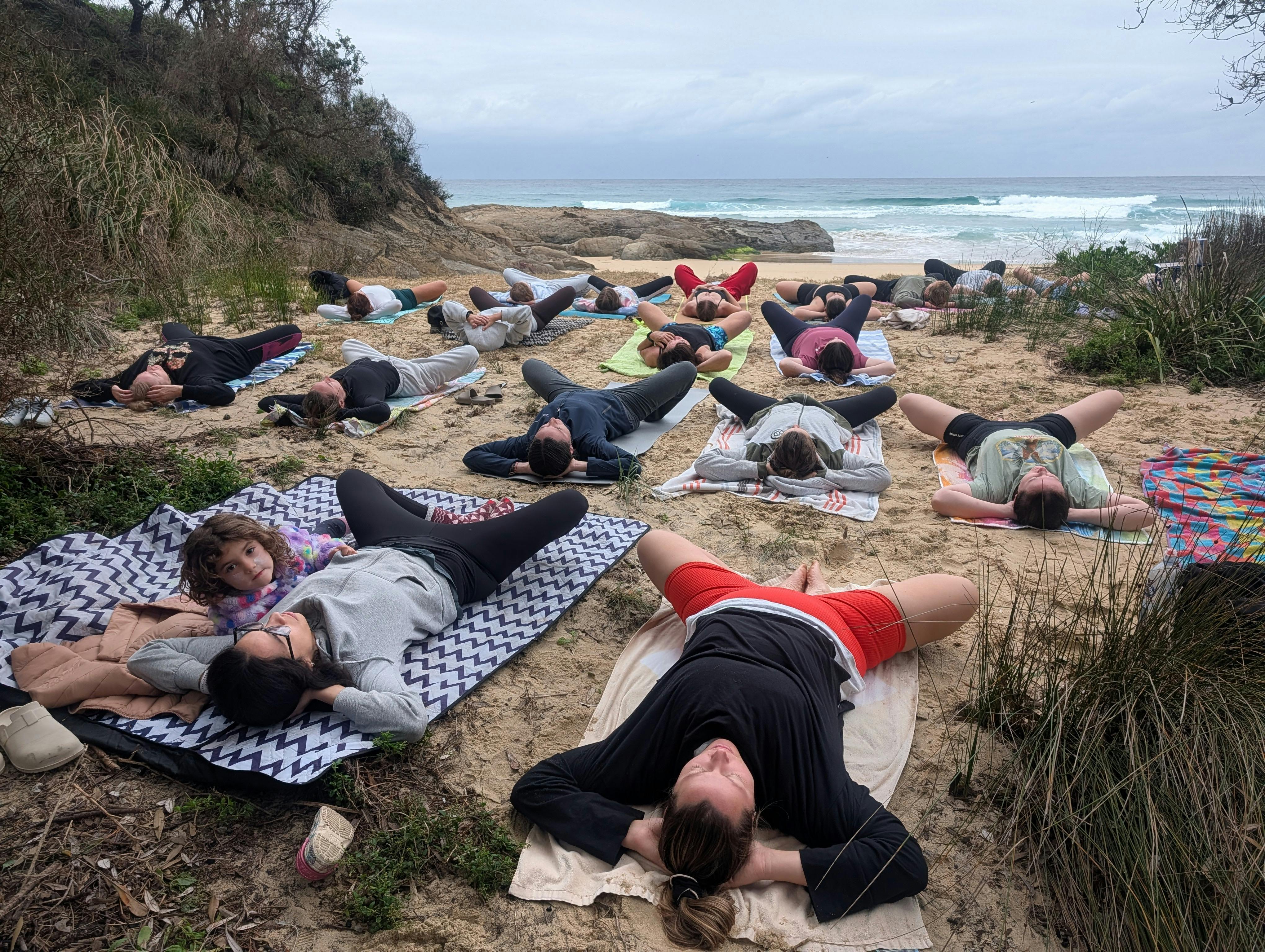 Restorative morning practice facing the ocean sunrise with our welcoming beach community.