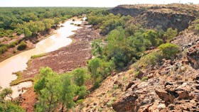 Muddy river seen from rocky outcrop.