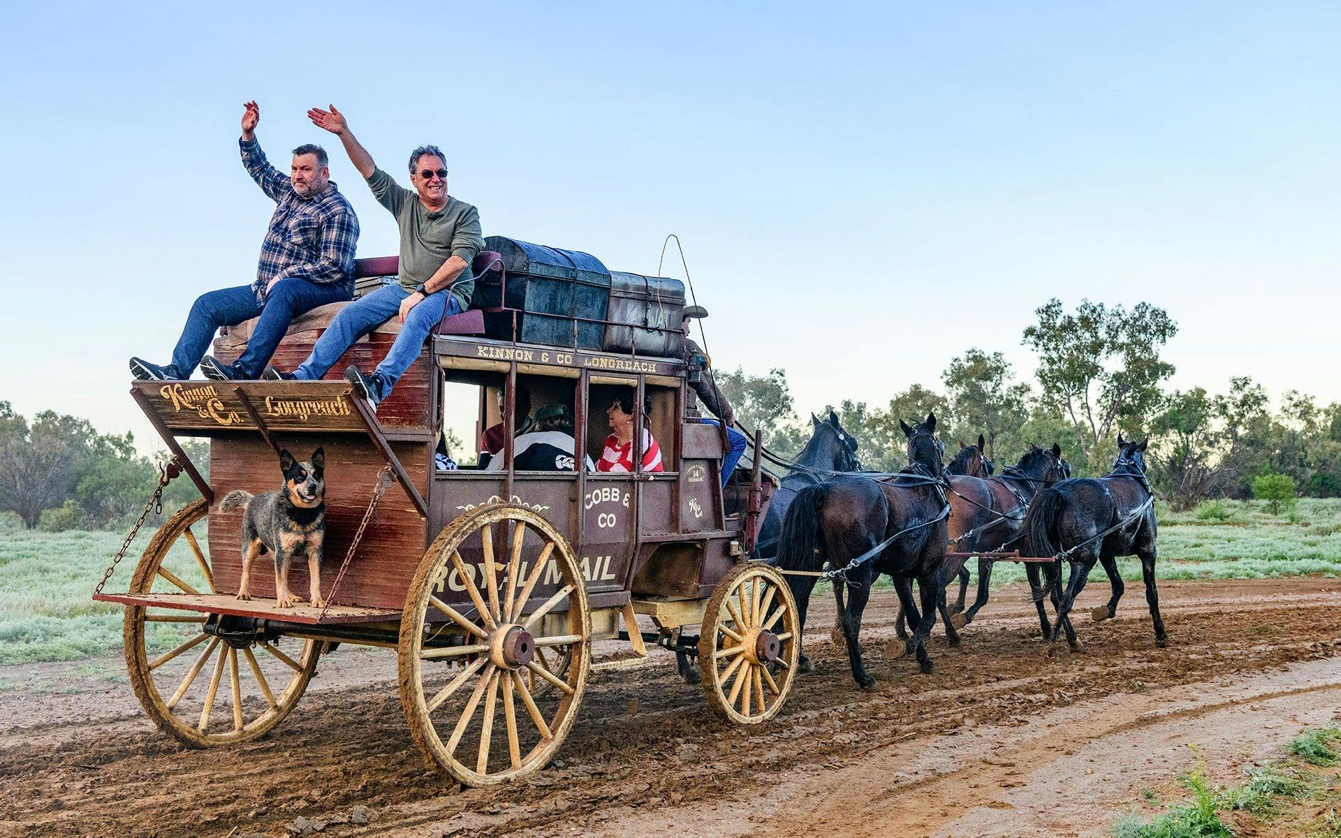 Two men sitting on the Kinnon & Co Stagecoach while horses are trotting away