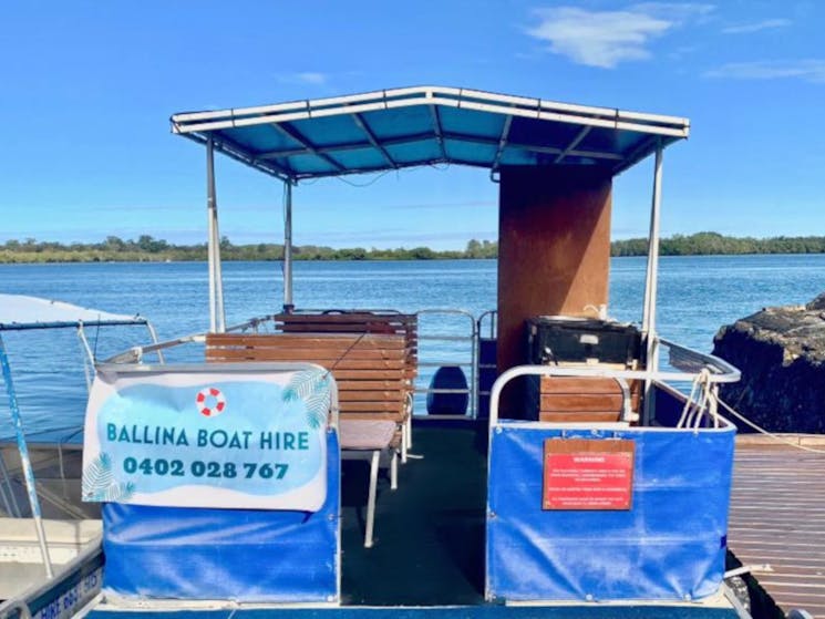 Hire boat on the river with signage out the front