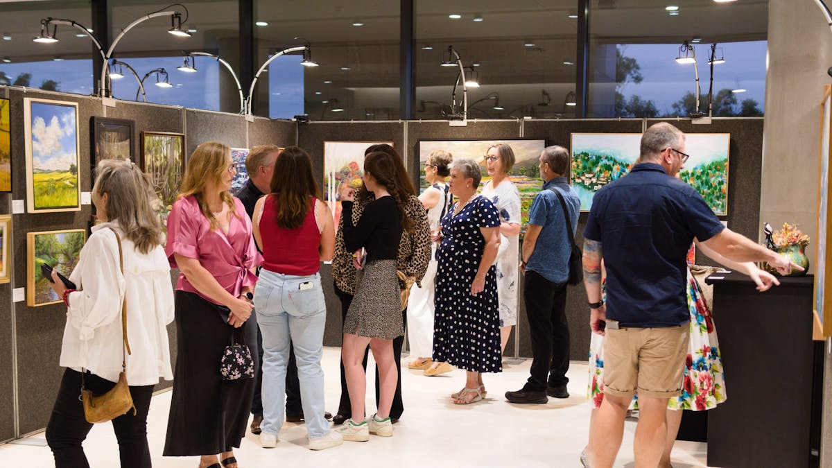 People looking at artworks