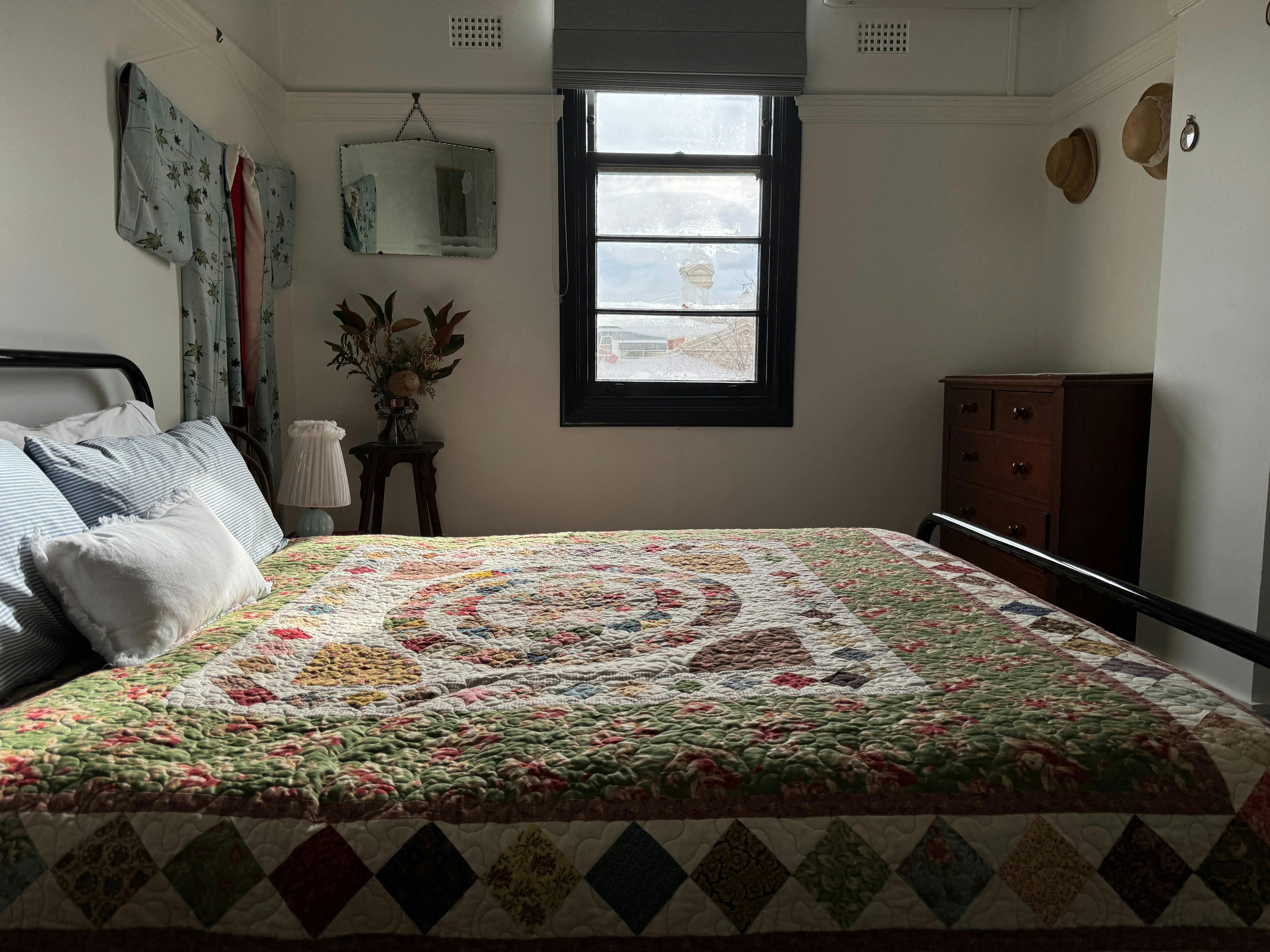 A vintage styled bedroom with an extraordinary quilt