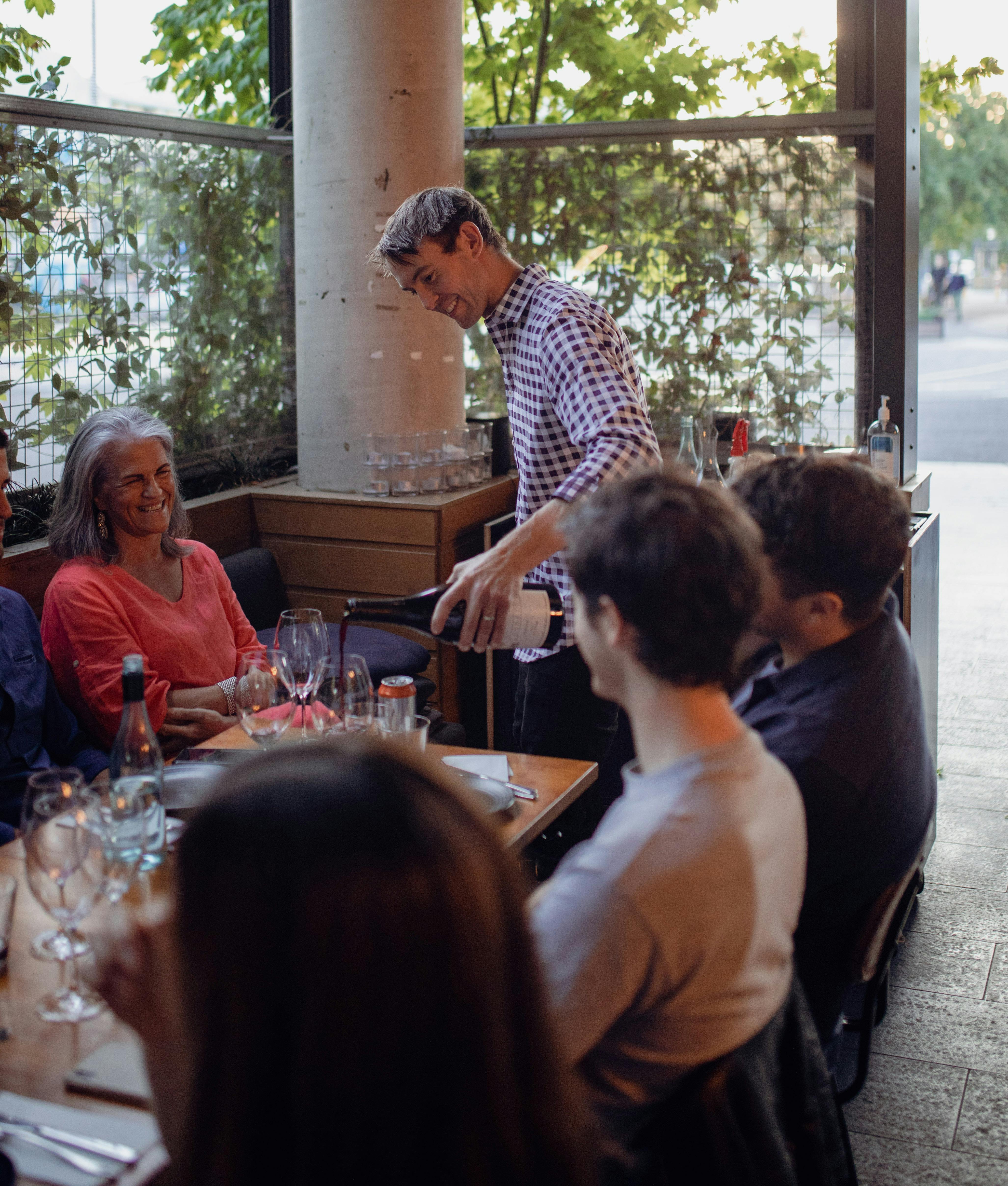 Somm Andy pouring wine