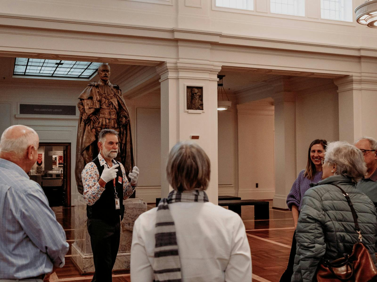 MoAD Experience Officer with a group of people gathered in King's Hall