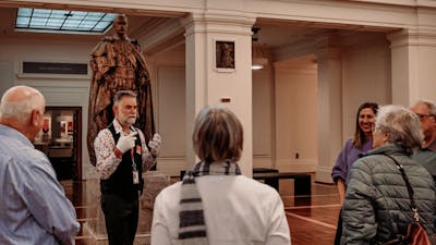 MoAD Experience Officer with a group of people gathered in King's Hall
